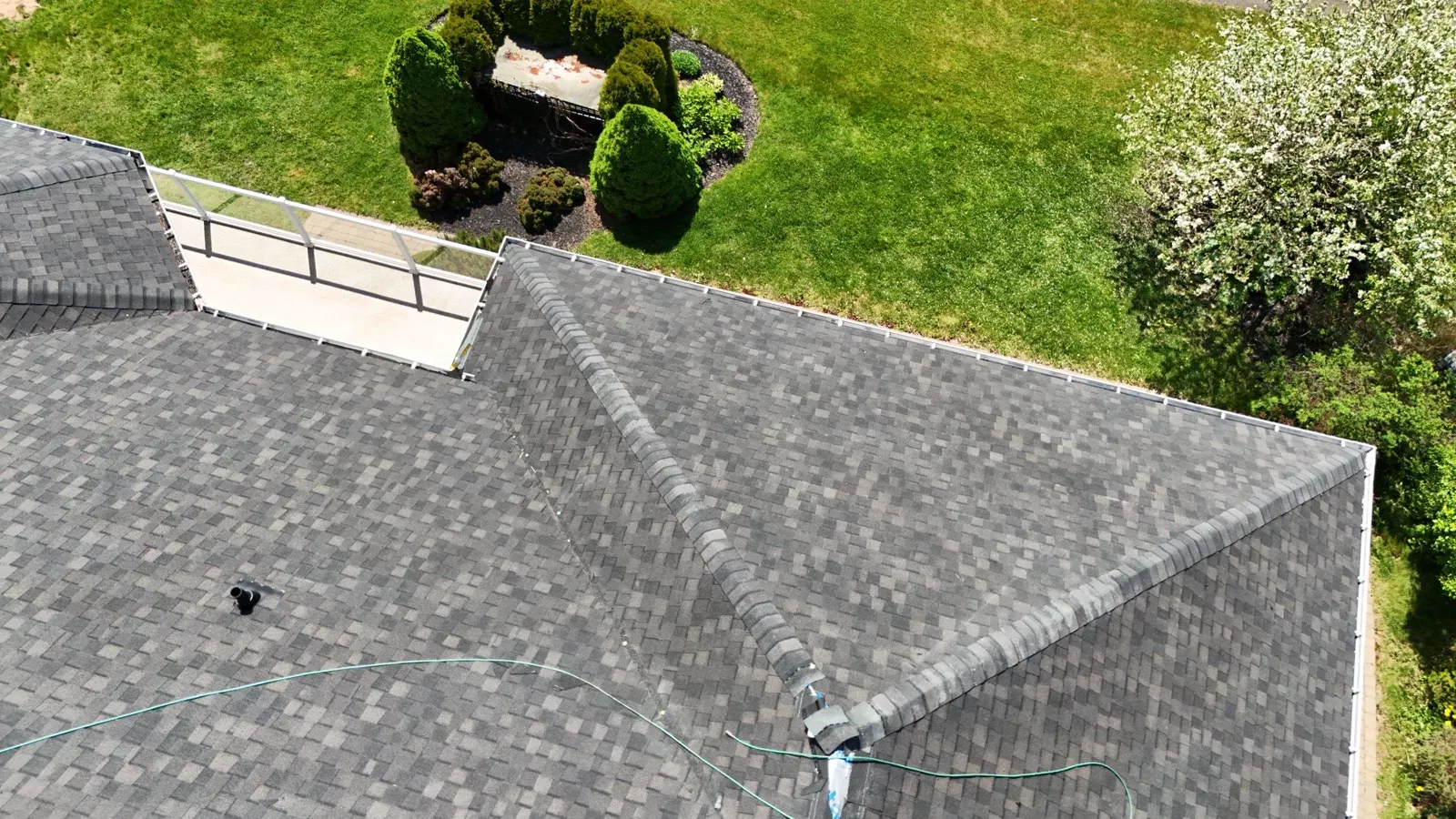 Clean hip and valley lines on a newly finished architectural shingle roof, drone detail
