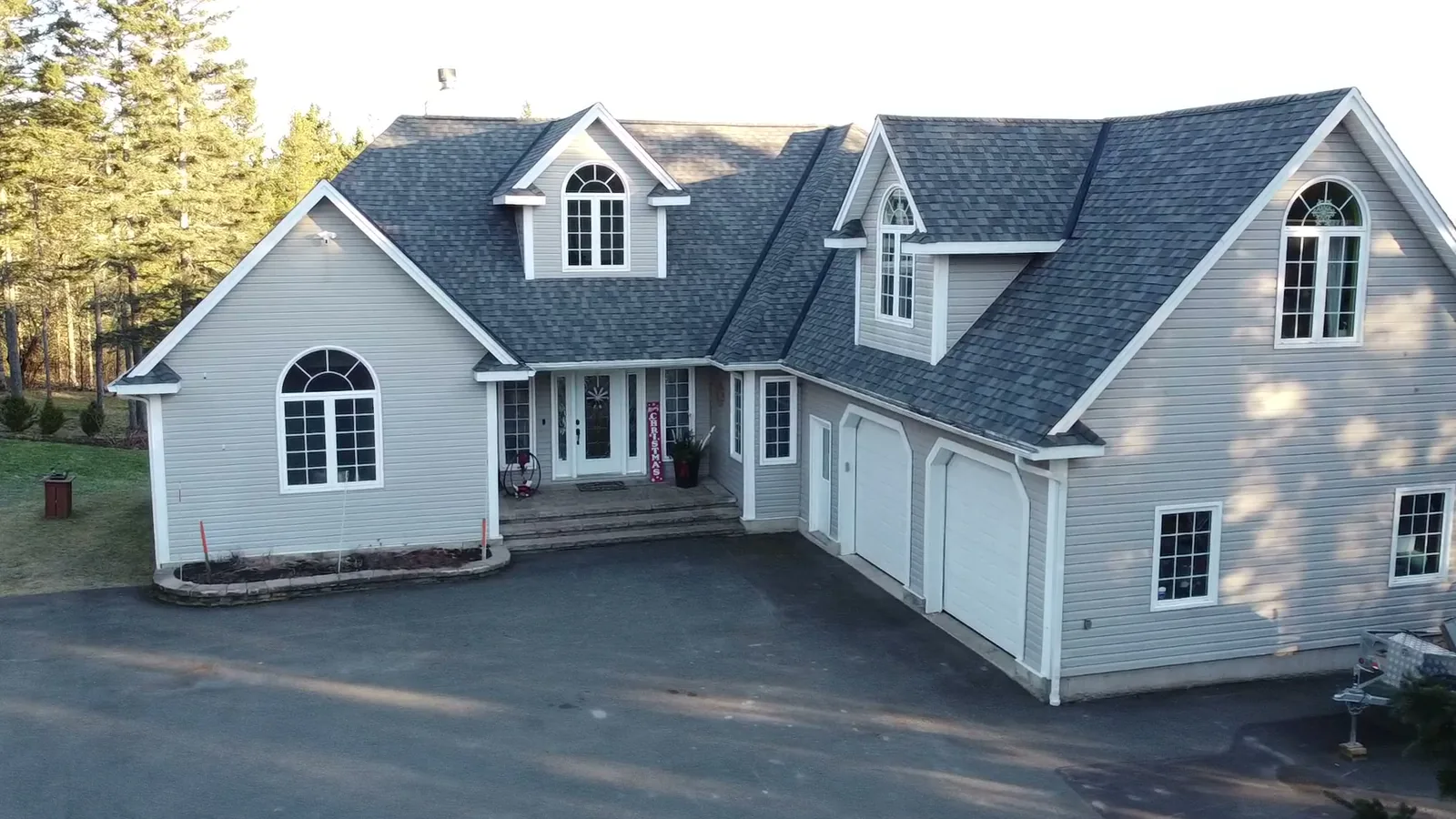 A finished estate reroof: new architectural shingles across every gable and dormer