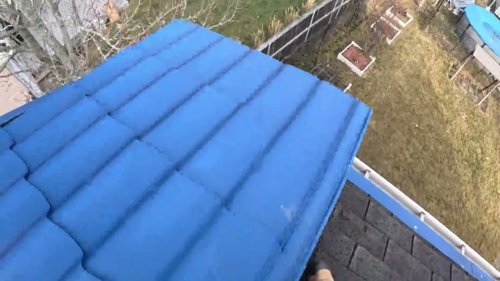 Steel tile panels laid over an existing asphalt shingle deck on a New Brunswick home