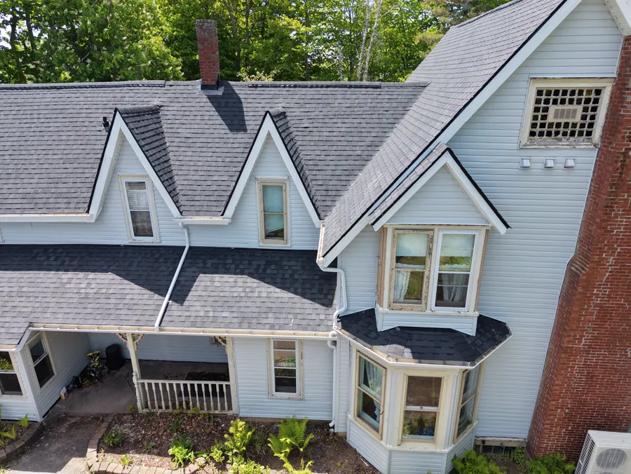 the Sackville Victorian front elevation after: restored Victorian with black roof and black turret gables